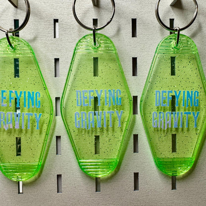Defying Gravity - Green Glitter Wicked Motel keyring