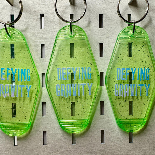 Defying Gravity - Green Glitter Wicked Motel keyring