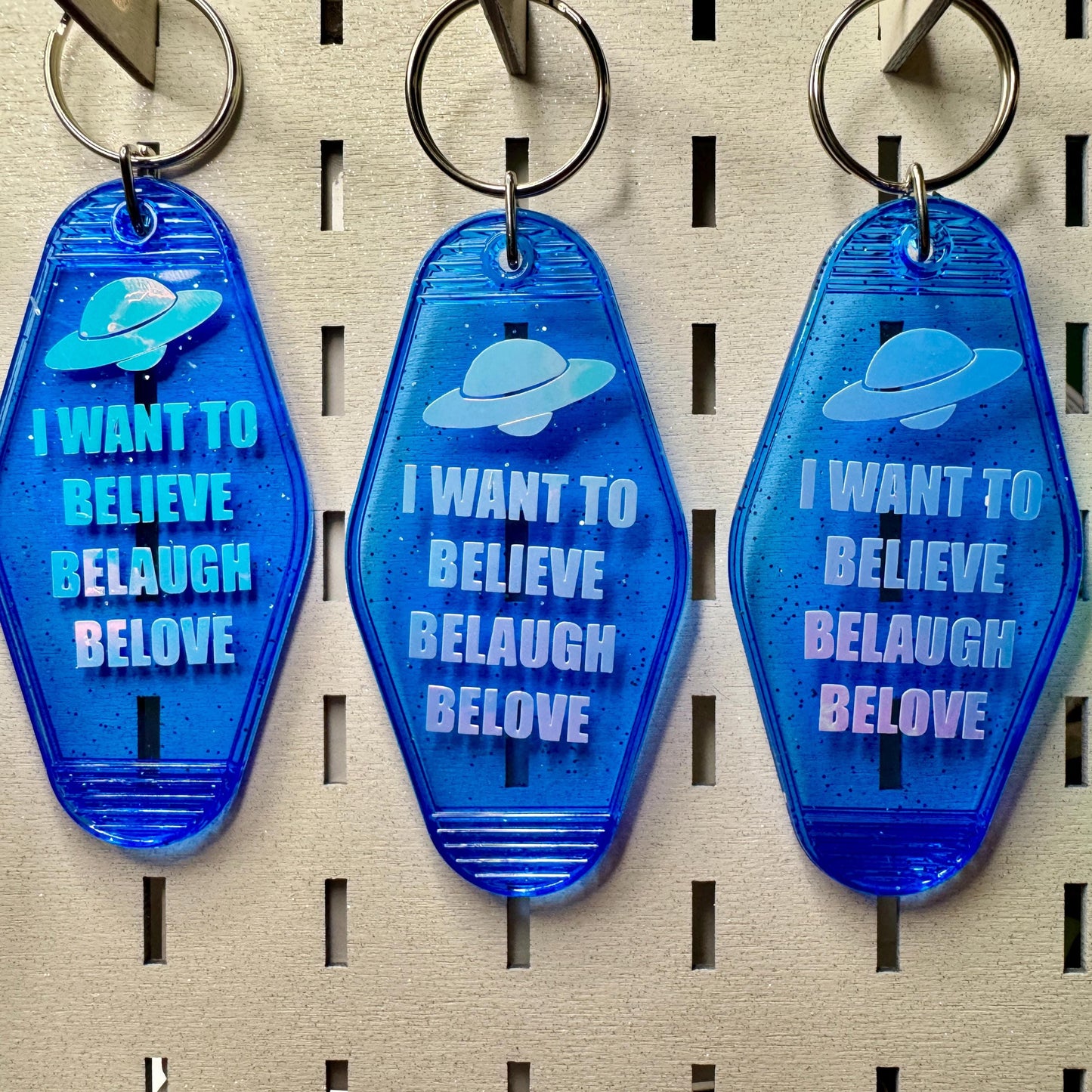 I want to Believe Belaugh Belove - blue glitter funny motel style keychain
