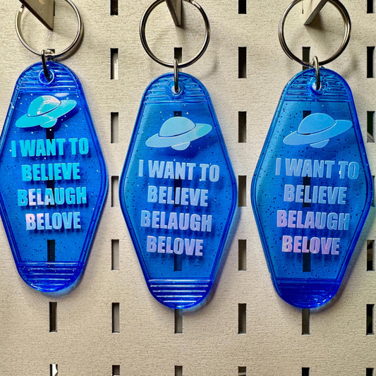I want to Believe Belaugh Belove - blue glitter funny motel style keychain